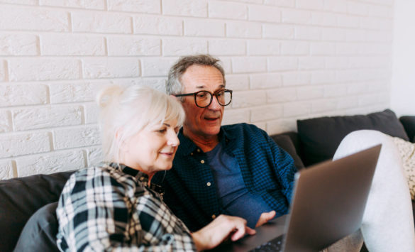 elderly couple using computer